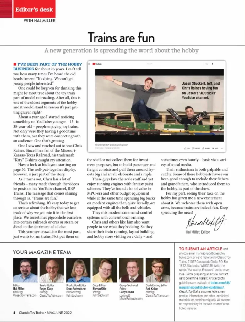 Man on train layout and another with two steam engines